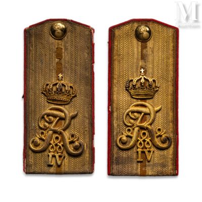two gold medals with a crown on each of them