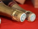 three bottles of champagne sitting on a red table