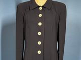 black coat with gold buttons on a mannequin base