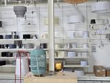 a large room with a lot of shelves and a ceiling fan