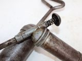 a metal object with a handle on it on a table