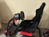 a red and black race car with a steering wheel and a steering wheel