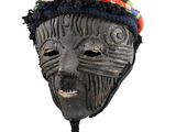 a black mask with a blue hat on top of it