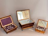 three wooden boxes with silverware in them on a table