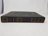 an old book sitting on top of a white table