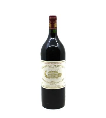 a bottle of red wine sitting on top of a white table