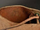 a close up of a brown leather bag with a handle