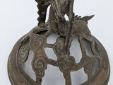 a bronze statue of a fish on top of a clock