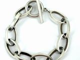 silver bracelet with a bar in the middle of the link