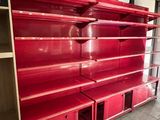 many empty shelves in a store with red paint on them