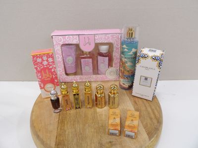 a wooden tray with a variety of perfumes on it