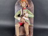 an image of a statue of a man sitting on a chair