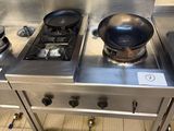 three stoves in the kitchen with a frying pan on top of them