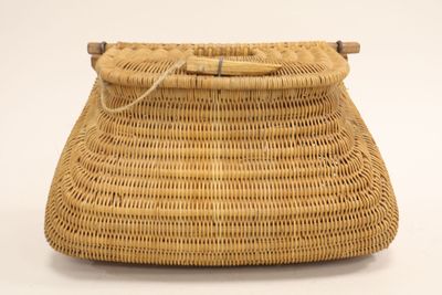 a close up of a wicker purse on a white background