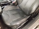 a picture of a car seat with a black leather cover