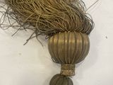 a close up of a piece of rope with a tassel on it