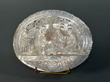 an antique silver plate with a scene of jesus and mary in the center