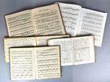 several sheets of music are spread out on a table