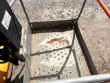 a metal cart with a yellow bucket on the ground