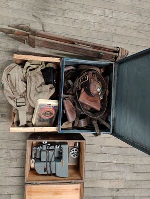 an overhead view of a suitcase filled with items on a wooden floor
