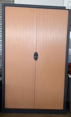 a wooden cabinet in the corner of a room