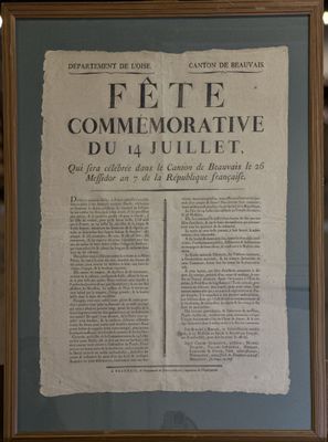 an old newspaper is hanging on a wall in a room