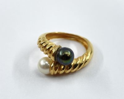 a close up of a gold ring with a pearl on it