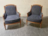 une paire de fauteuils rembourrés bleus dans une pièce, avec un mur en arrière-plan