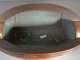 a metal bowl that is sitting on a table