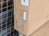 boxes are stacked on top of each other in front of a metal cage
