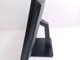a computer monitor sitting on a stand on a white surface