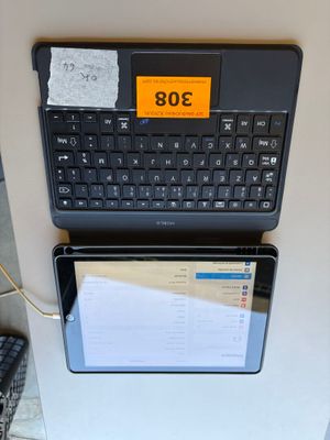 two laptops sitting next to each other on the wall