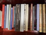 many books that are on a book shelf together