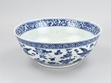 a blue and white bowl with a floral design on the rim