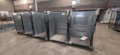 four refrigerators in a large room with a lot of shelves