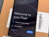 the back of a black samsung phone sitting on top of a cardboard box