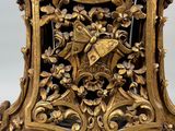 a gold clock that is sitting on a table