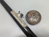 a pen and a button on a white table