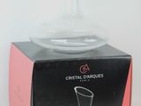 a clear glass vase sitting on top of a box