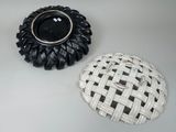 two black and white plates sitting on a table