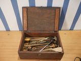 a wooden box with tools in it on a table