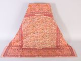 an orange and pink floraled shawl on a white background
