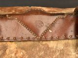 an old suitcase with a leather handle and rivets on it