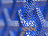 a close up of a blue and white tie with a name on it