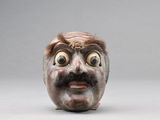 une sculpture en céramique représentant un homme avec une moustache et une barbe