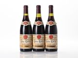 three bottles of wine sitting next to each other on a white surface