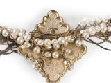 an image of a close up of a brooch with pearls on it
