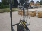 a crane that is sitting on a stand in the dirt