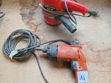 two electric tools that are on a table