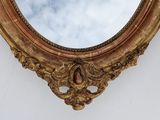 a mirror on the wall with a sky in the background